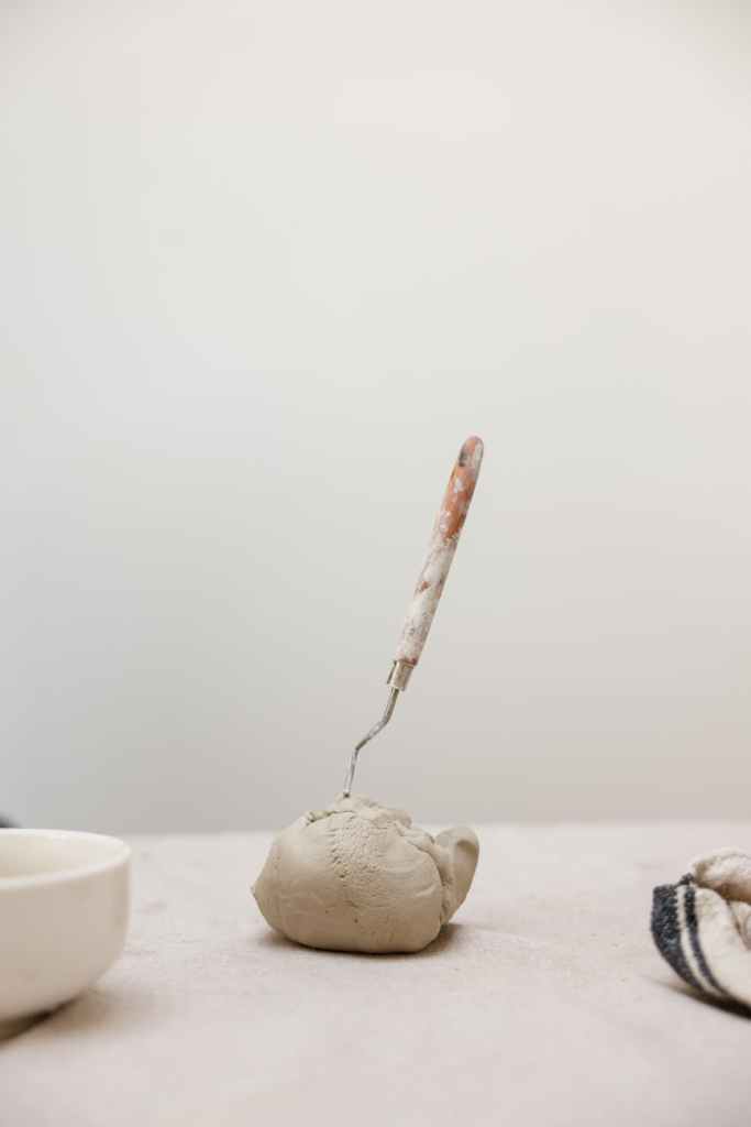 a ball of clay with a spatula stuck in it